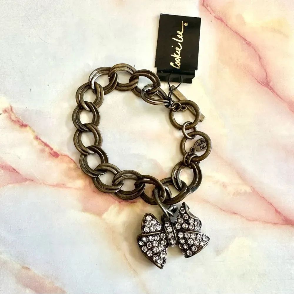 Cookie Lee brass tone pave rhinestone bow bracelet